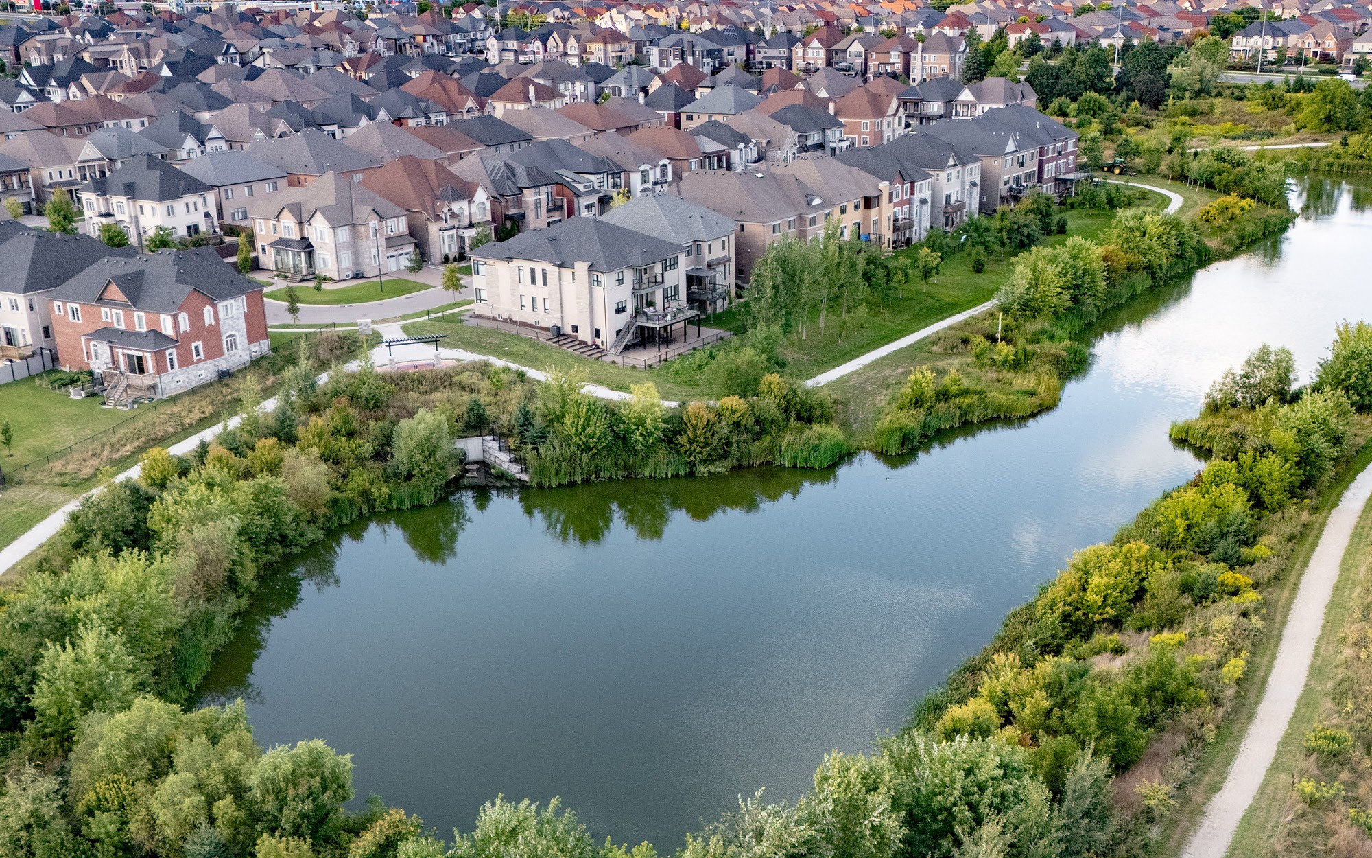 Overhead view of a community development next to water.