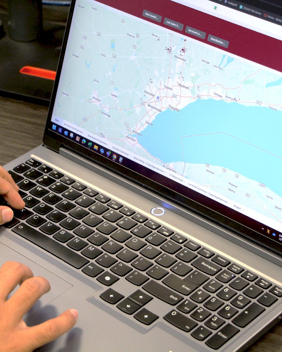 Viewing DG Group community development areas on a laptop.