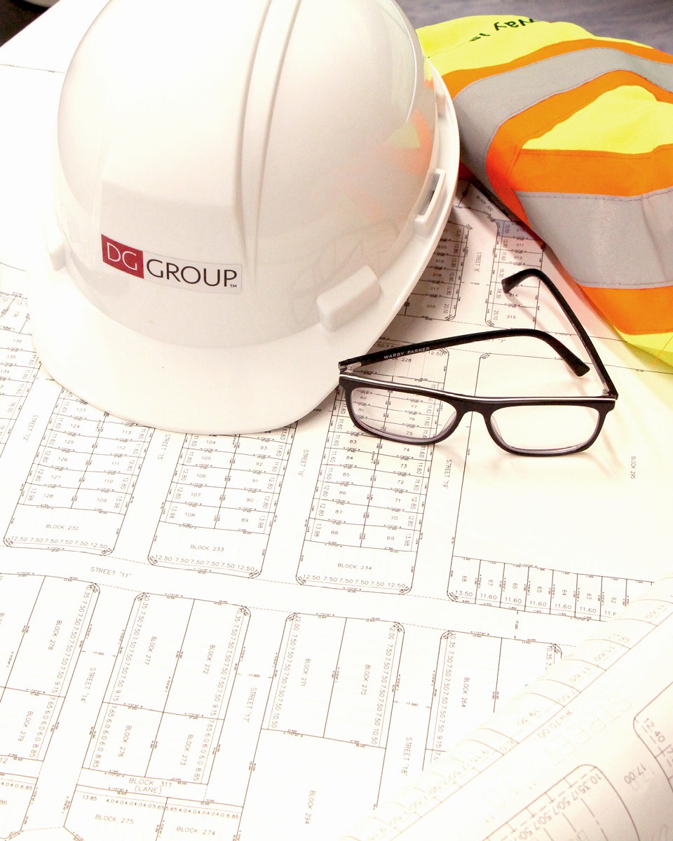Urban Planning documents with hard helmet, glasses and safety vest.