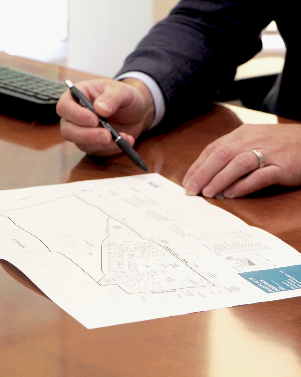 DG Group staff reviewing urban planning document.