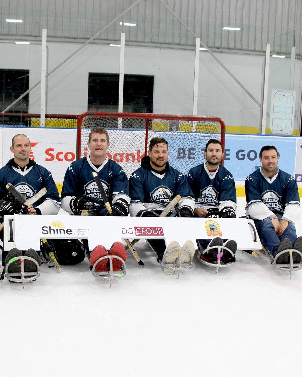 A team photo with DG Group staff at a sponsored a hockey event.